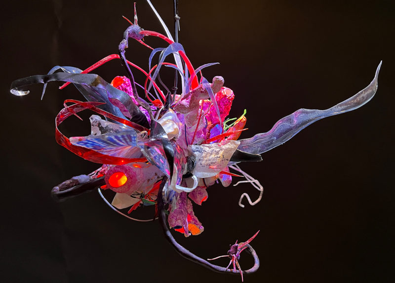 "Faux Ecologies / the Anthropocene Gardens + Artificial Reefs of the Nature-verse #7" 2014-2023 /free-hanging sculptures/ reclaimed Ocean debris [sponges,seafans, and dead corals], up-cycled plastics from beach clean-ups and the artist's personal waste stream, LED's, fiber optics, acrylic paint, epoxy by [dNASAb]