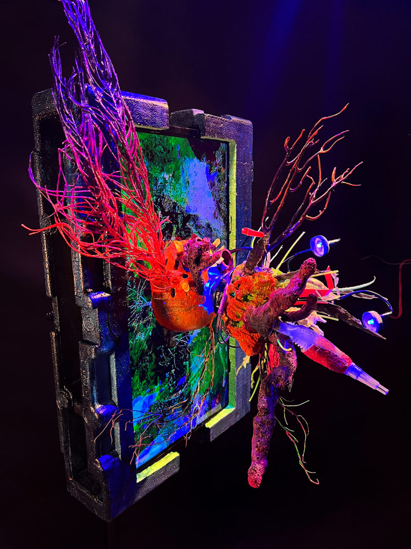 &ldquo;Obscene Plasticene Daydream; LCD Artificial ReefLine /Faux Ecologies&rdquo; _video sculpture 2022/_ LCD screen, reclaimed ocean styrofoam, upcycled marine debris+ plastics from beach cleanups (bottle caps,syringe,kids toys,monofilament,..) screen shipping materials, recycled plastic, epoxy, resin, airbrush paints, fiber optics, LED&rsquo;s, unique 4K video of temporary sculptures filmed underwater on Coral Reefs in South Florida