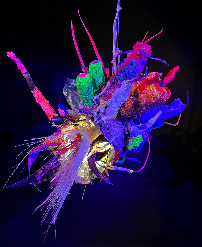 "Faux Ecologies / the Anthropocene Gardens + Artificial Reefs of the Nature-verse #2" 2023 /free-hanging sculptures/ reclaimed Ocean debris [sponges,seafans, and dead corals], up-cycled plastics from beach clean-ups and the artist's personal waste stream, LED's, fiber optics, acrylic paint, epoxy by [dNASAb]