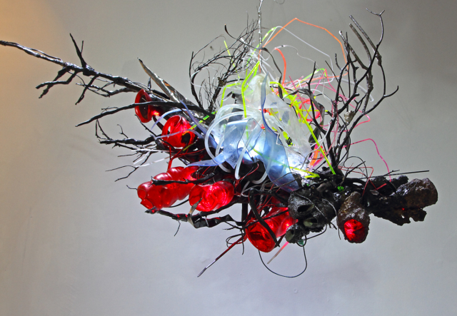 “Vortex_Plasticized Gyre #3” 2015 Resin, acrylic, reclaimed plastics, paint, wood, thermal formed plastics, archival imaged plastics, reclaimed corals and sponges, led’s. 21(h) x 17(w) x42(l) inches
