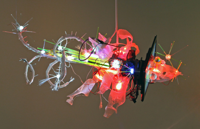 “Dataclysmic #2”, 2010. LED screen, Digital Media Player, LEDs, steel, silicon, plastic, fiber optics, 720P HD video, with video projection. Dimensions variable. Gallery installation. dNASAb